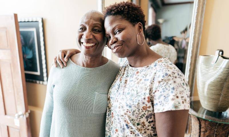 Two women standing together smiling