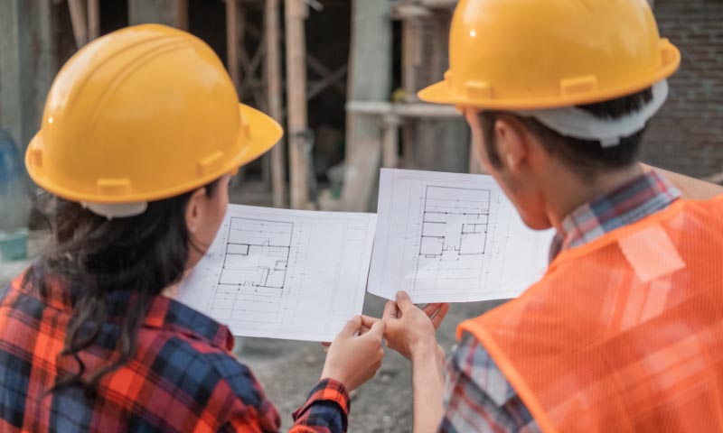 Two construction workers comparing plans