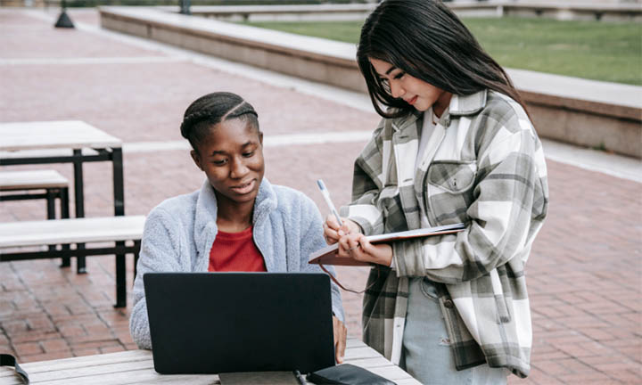 Students sat outside helping each other study